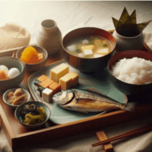 A traditional Japanese breakfast consists of rice, miso soup, grilled fish, pickles, and seaweed beautifully arranged on a neat tray.