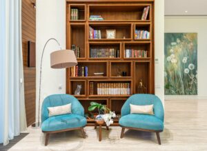 A minimalist living room with a decluttered and serene atmosphere, featuring a cozy couch and neatly arranged shelves.