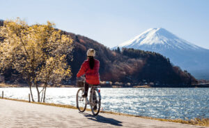 Cyclist riding through a scenic Japanese countryside.