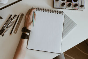 Left-handed person writing with their left hand, symbolizing the increased likelihood of left-handedness in November-born people.