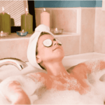 Woman relaxing in a bathtub with cucumber slices on her eyes to reduce dark circles.