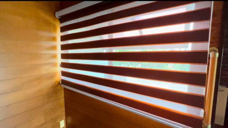 Entrance window with dimmable roll blinds for privacy and light control.