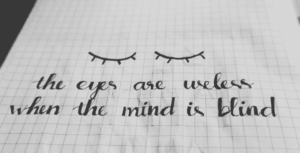 A handwritten “i” letter with varied specific style, illustrating personality traits tied to confidence and introspection.