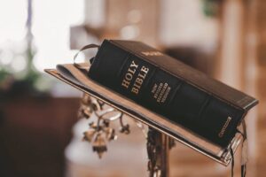 Open Bible on a wooden table.