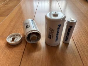 Panasonic battery spacers with AA rechargeable batteries, demonstrating their conversion to D or C-sized batteries.